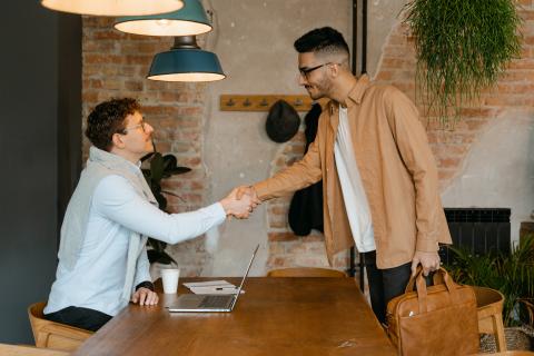 Two men standing and shaking hands