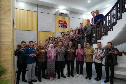 Attendees of a meeting at IAI headquarters on a staircase