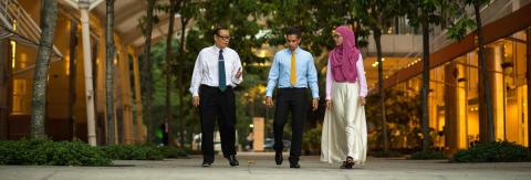 Three business people walking in Indonesian city