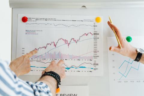 Hands near charts showing growth